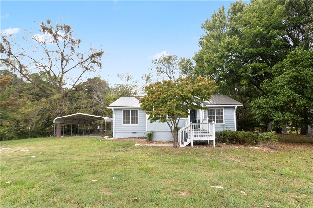 a front view of house with yard and trees