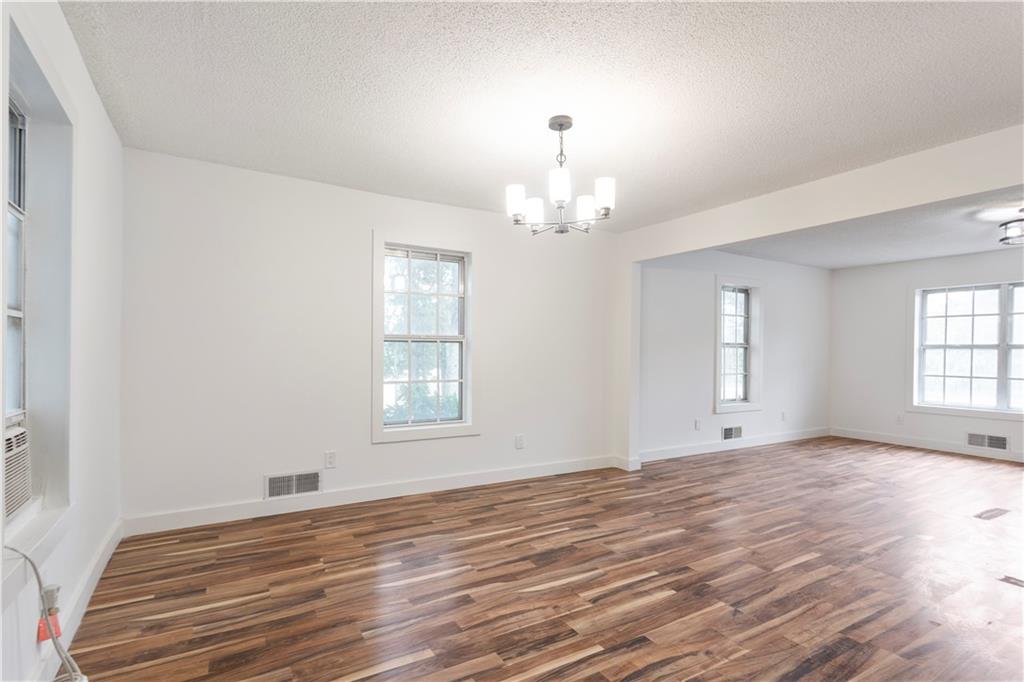4361 Ben Hill Road Lithia Springs, GA 30122 - Photo 13 of 35 a view of empty room with wooden floor and fan