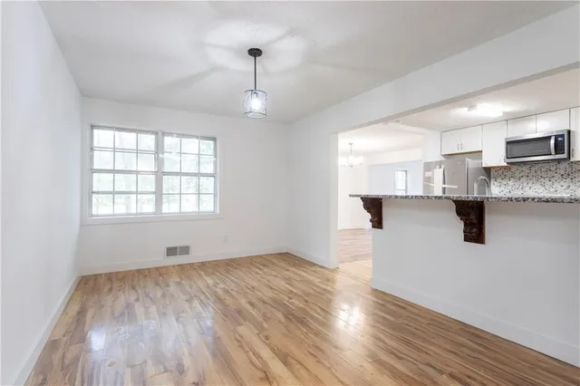 a view of a kitchen with a sink and a window