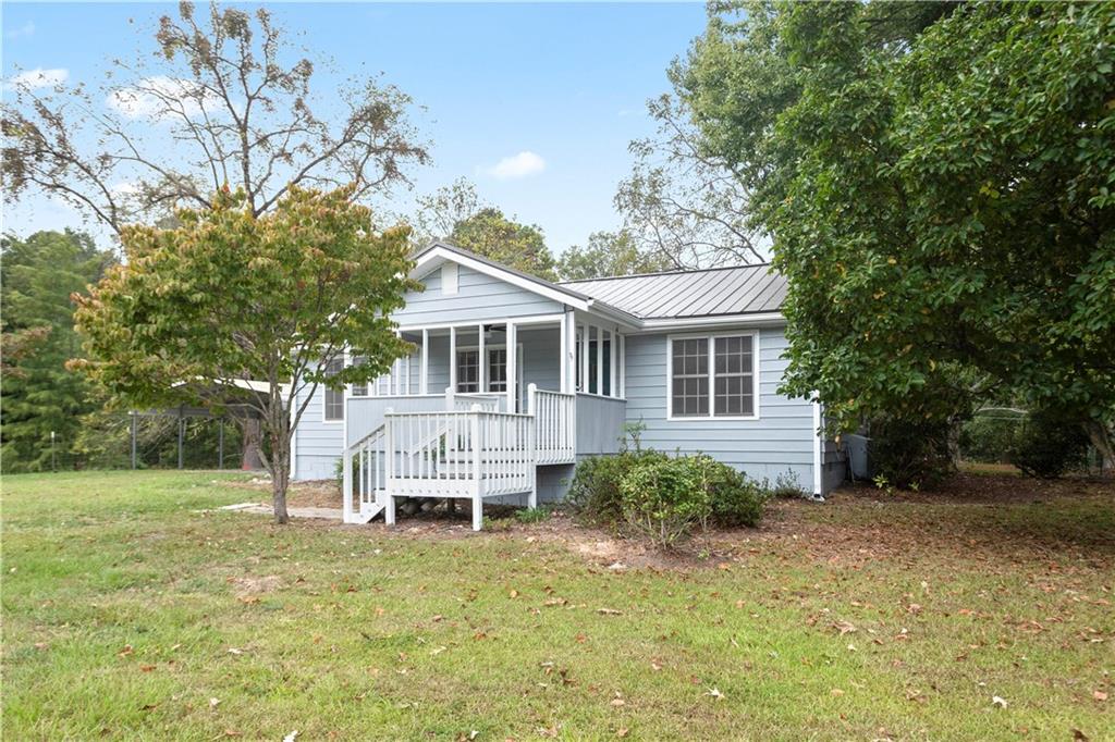 4361 Ben Hill Road Lithia Springs, GA 30122 - Photo 2 of 35 a front view of a house with a yard