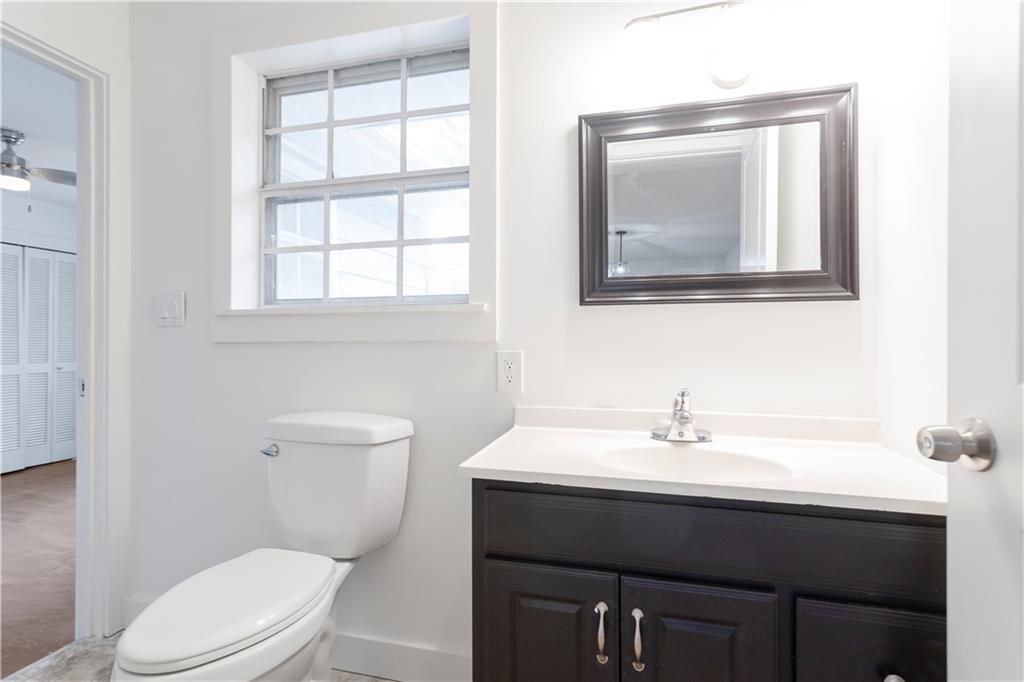 4361 Ben Hill Road Lithia Springs, GA 30122 - Photo 23 of 35 a bathroom with a toilet sink and mirror
