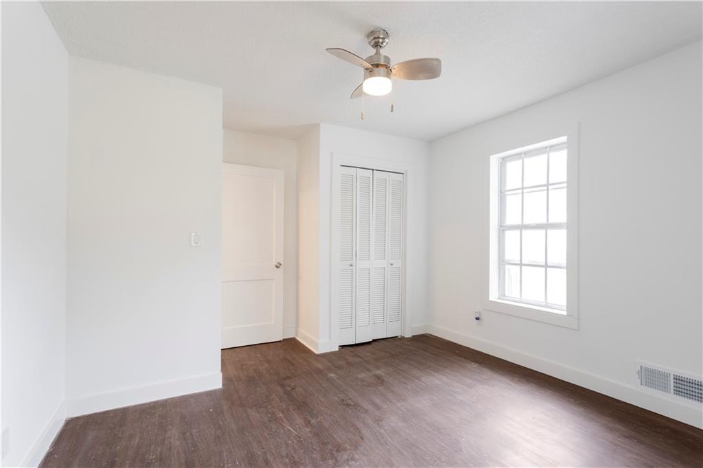 4361 Ben Hill Road Lithia Springs, GA 30122 - Photo 24 of 35 an empty room with windows and ceiling fan