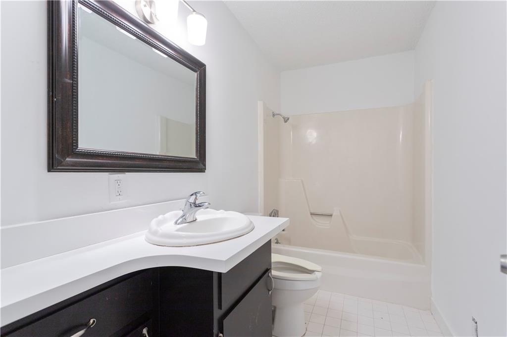 4361 Ben Hill Road Lithia Springs, GA 30122 - Photo 31 of 35 a bathroom with a sink a toilet and shower