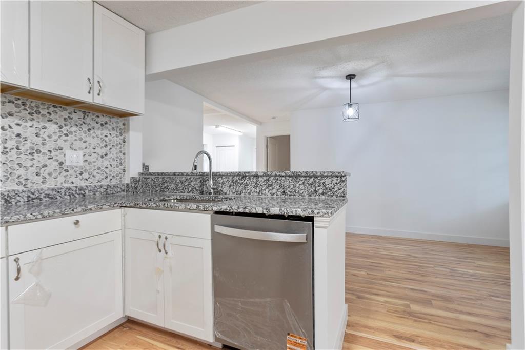4361 Ben Hill Road Lithia Springs, GA 30122 - Photo 32 of 35 a kitchen with granite countertop a sink and cabinets