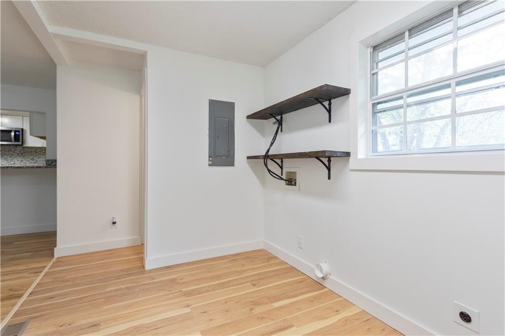 4361 Ben Hill Road Lithia Springs, GA 30122 - Photo 33 of 35 an empty room with a window and wooden floor