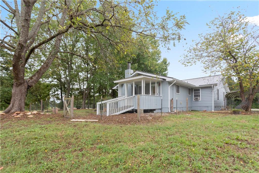 4361 Ben Hill Road Lithia Springs, GA 30122 - Photo 4 of 35 a white house that has a tree in front of the house