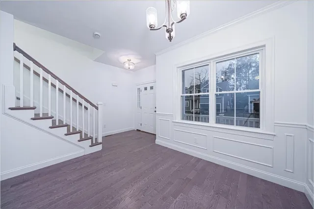 a view of an entryway with wooden floor and windows