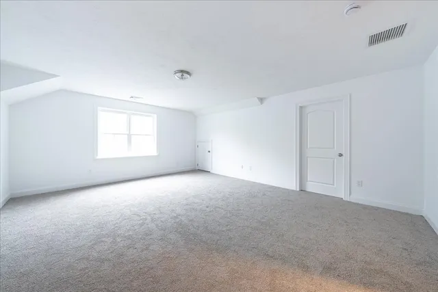 an empty room with a window and closet