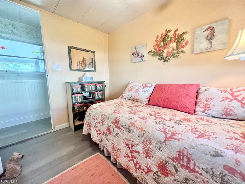 112 Cape Sable Drive Naples, FL 34104 - Photo 11 of 25 a bedroom with a bed and a painting on the wall