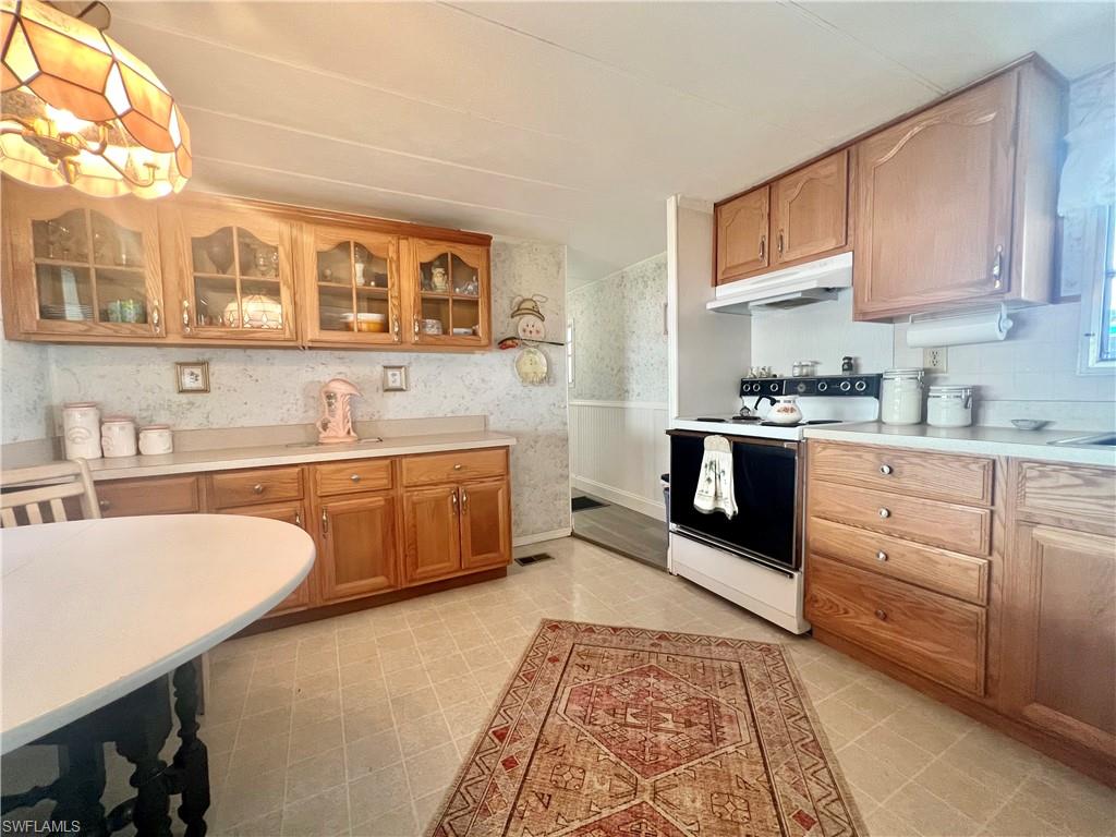 112 Cape Sable Drive Naples, FL 34104 - Photo 12 of 25 a kitchen with stainless steel appliances granite countertop a sink and cabinets
