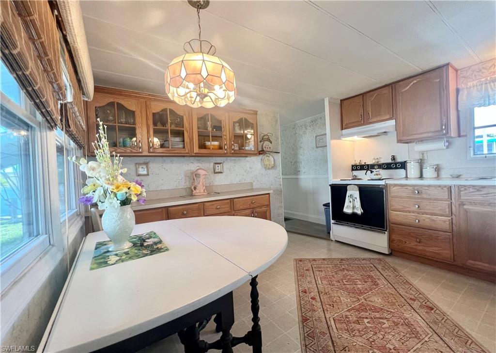 112 Cape Sable Drive Naples, FL 34104 - Photo 14 of 25 a kitchen with cabinets and chandelier