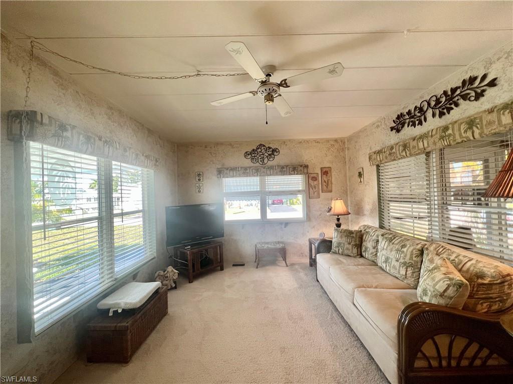 112 Cape Sable Drive Naples, FL 34104 - Photo 16 of 25 a living room with furniture and a large window