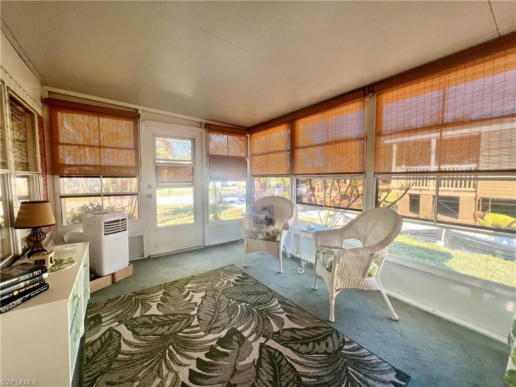 112 Cape Sable Drive Naples, FL 34104 - Photo 18 of 25 a living room with a couch and large windows