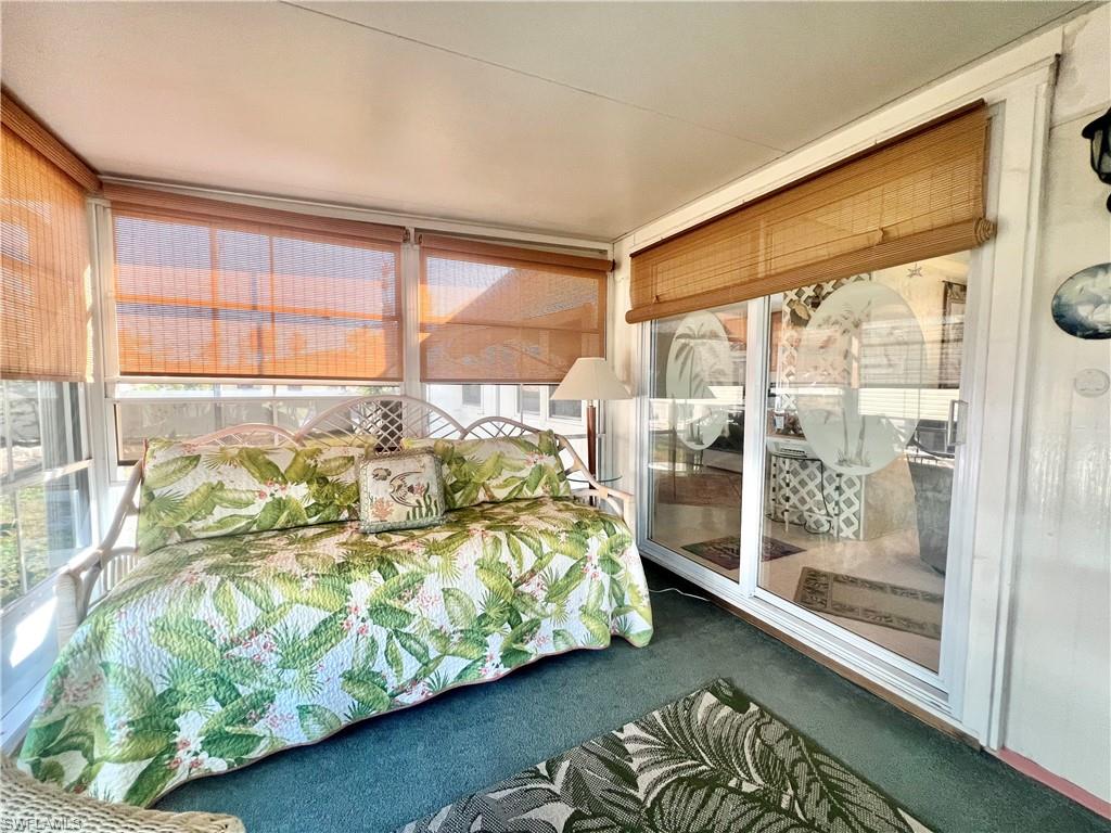 112 Cape Sable Drive Naples, FL 34104 - Photo 19 of 25 a bed sitting in a bedroom next to a window