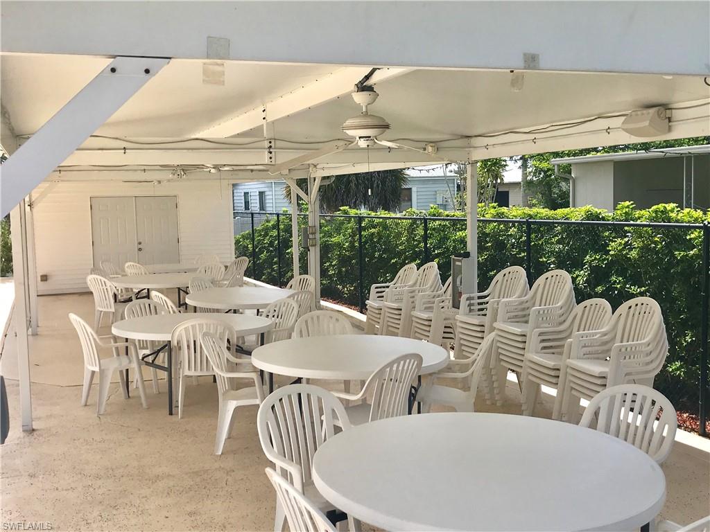 112 Cape Sable Drive Naples, FL 34104 - Photo 23 of 25 a dinning table and chairs in a patio
