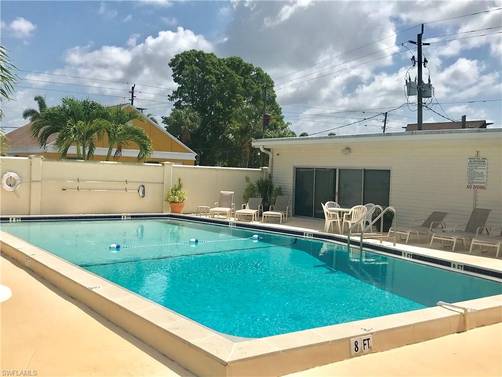 112 Cape Sable Drive Naples, FL 34104 - Photo 24 of 25 a view of a swimming pool with a lounge chairs