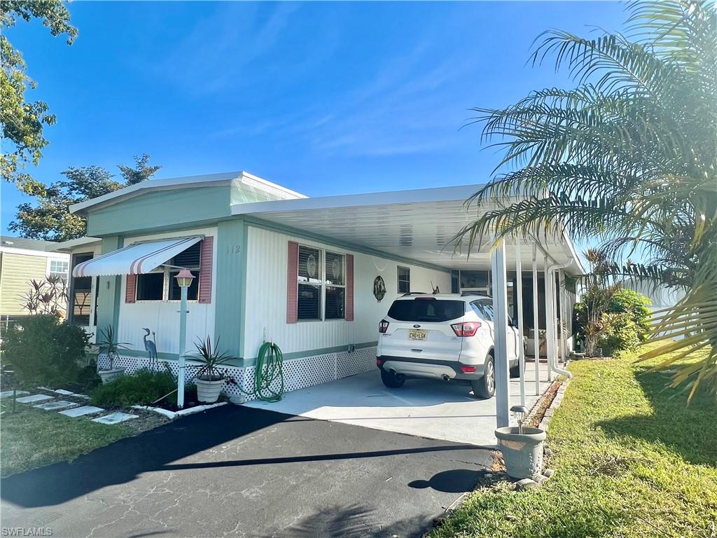 112 Cape Sable Drive Naples, FL 34104 - Photo 3 of 25 a front view of a house with garden
