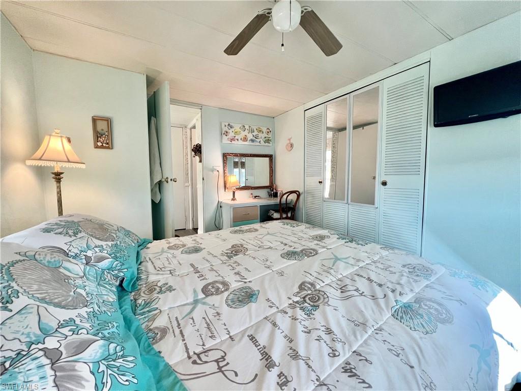 112 Cape Sable Drive Naples, FL 34104 - Photo 5 of 25 a bedroom with a bed and a chandelier