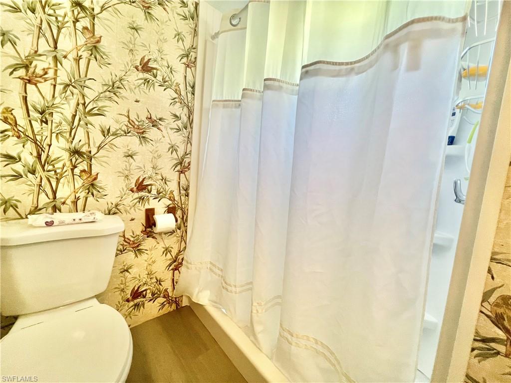 112 Cape Sable Drive Naples, FL 34104 - Photo 8 of 25 a bathroom with a toilet and a shower