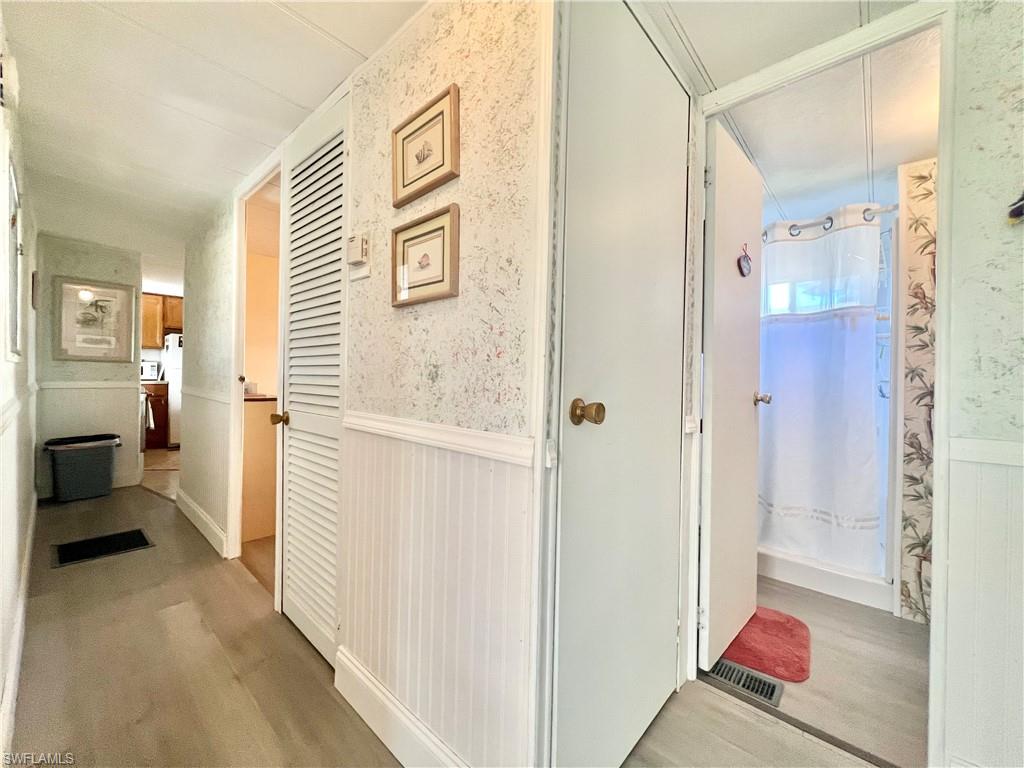 112 Cape Sable Drive Naples, FL 34104 - Photo 9 of 25 a view of a hallway with bathroom and shower