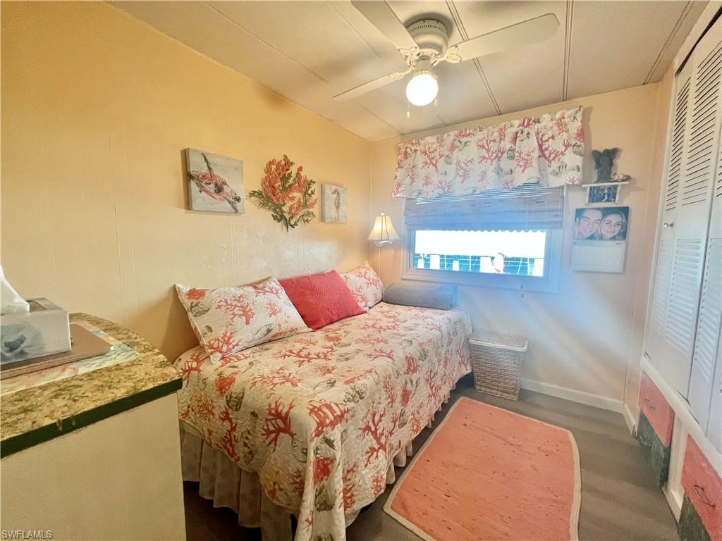 112 Cape Sable Drive Naples, FL 34104 - Photo 10 of 25 a bedroom with a bed and a chandelier