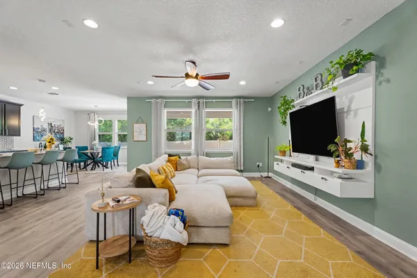 a living room with furniture and a flat screen tv