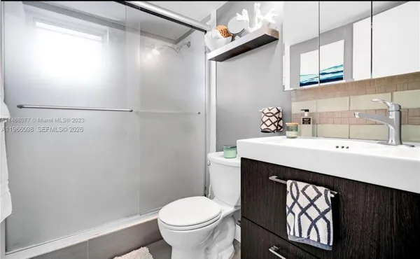 a bathroom with a sink a toilet and mirror