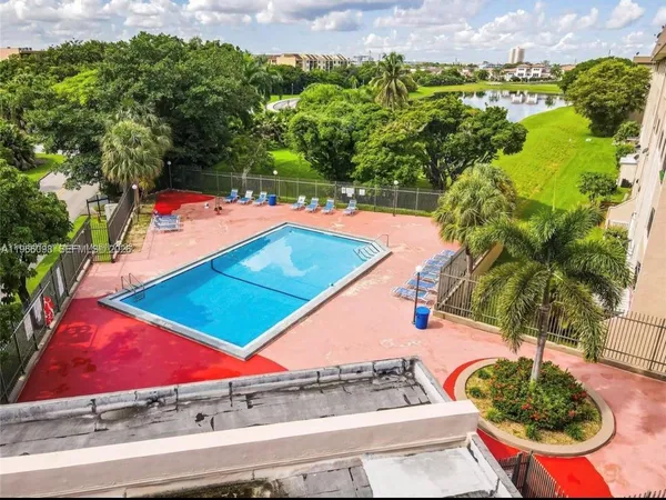 a view of a swimming pool with a yard