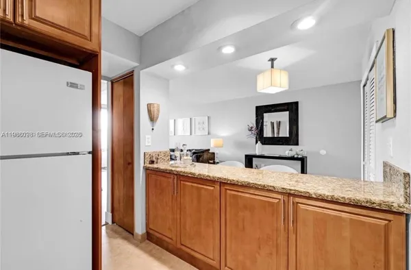 a kitchen with sink and refrigerator