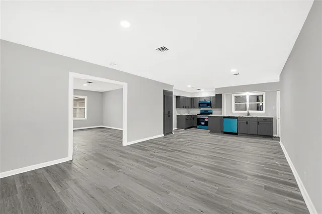 a view of a kitchen with a sink and a stove top oven