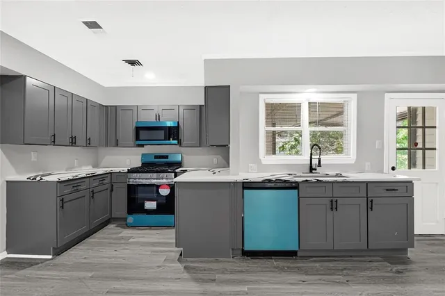 a kitchen with a sink and wooden cabinets