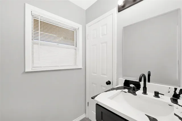 a bathroom with a sink and a mirror
