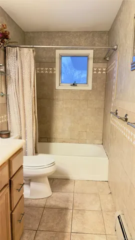 a view of backyard with plants and wooden fence