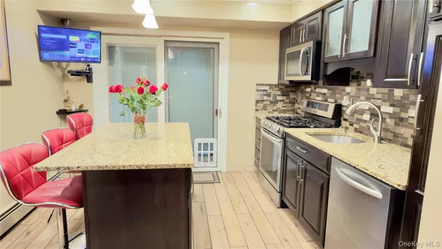 a living room with patio furniture and a flat screen tv