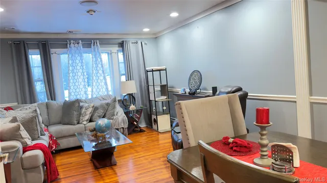 a bedroom with a bed and a flat tv screen on the dresser