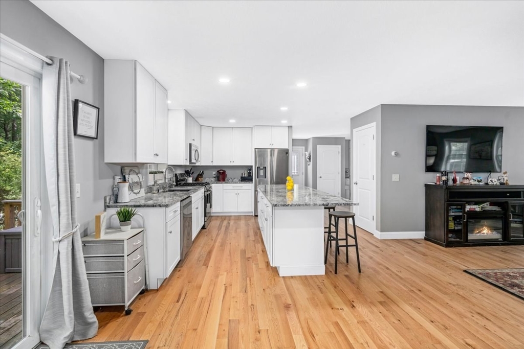 61 Blake Road Epping, NH 03042 - Photo 14 of 41 a kitchen with white cabinets and stainless steel appliances