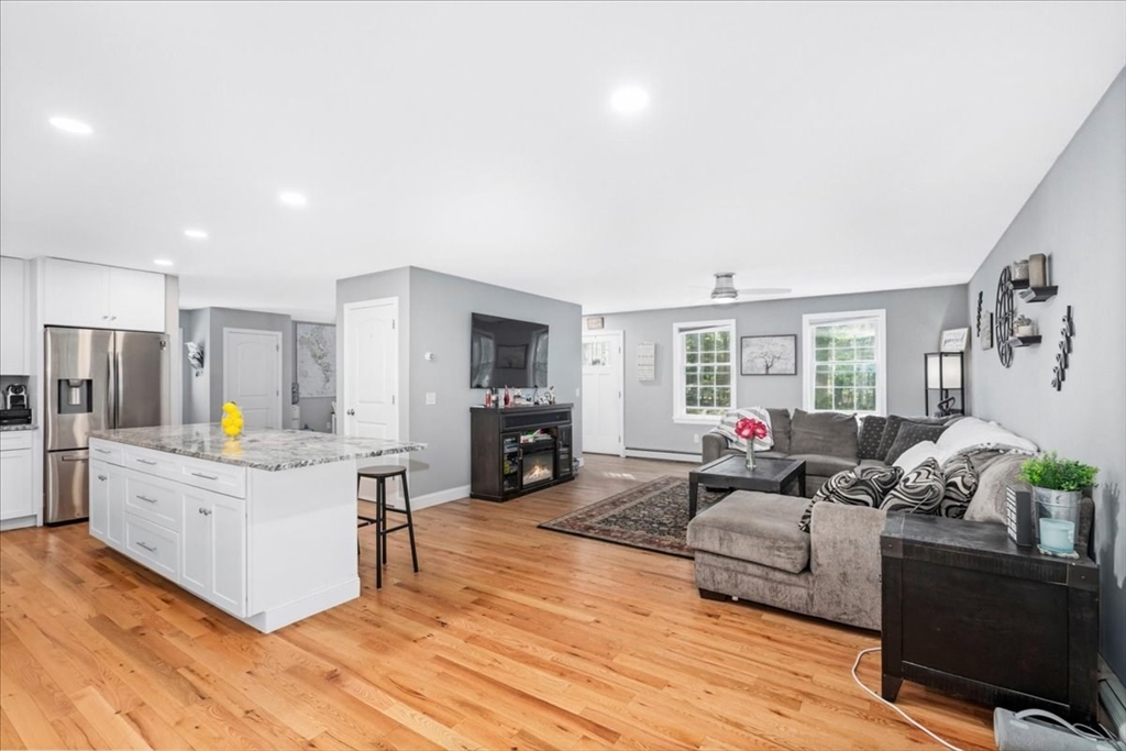 61 Blake Road Epping, NH 03042 - Photo 15 of 41 a living room with furniture and a fireplace