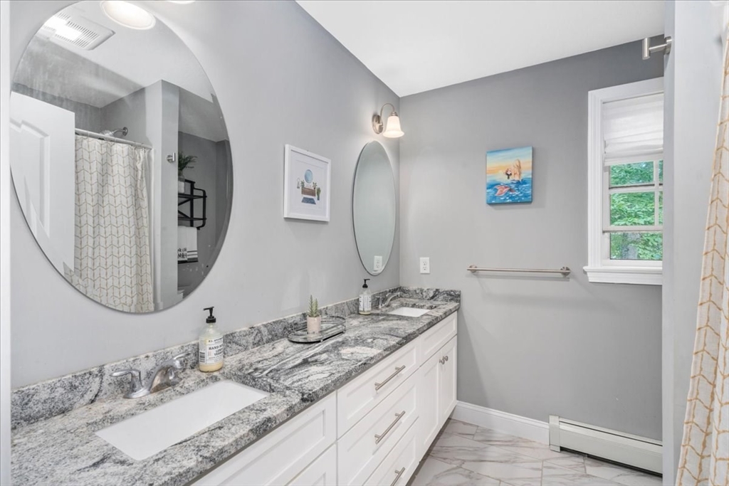 61 Blake Road Epping, NH 03042 - Photo 26 of 41 a bathroom with a double vanity sink and a mirror