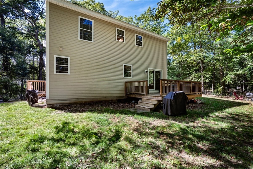 61 Blake Road Epping, NH 03042 - Photo 3 of 41 a view of backyard with deck and garden
