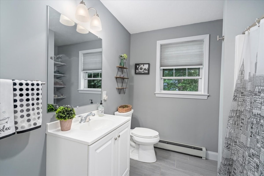 61 Blake Road Epping, NH 03042 - Photo 31 of 41 a bathroom with a sink a toilet and mirror