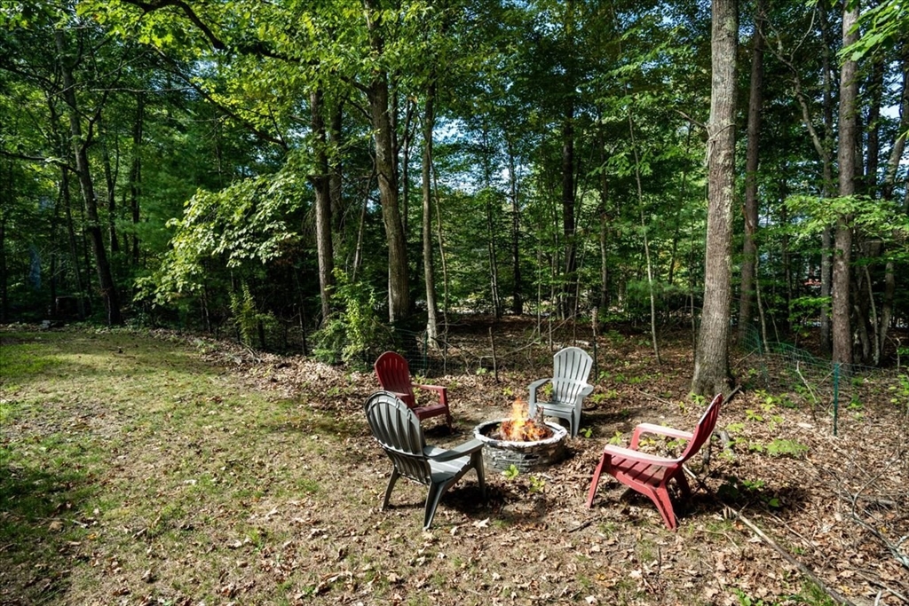 61 Blake Road Epping, NH 03042 - Photo 41 of 41 a view of a wooden chairs and table in the backyard