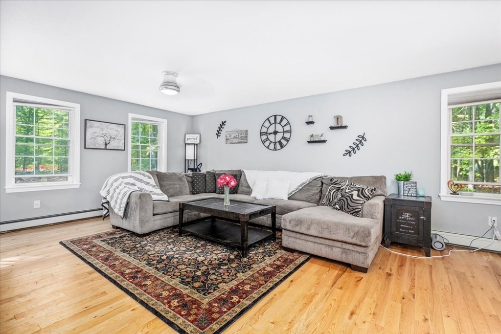 61 Blake Road Epping, NH 03042 - Photo 5 of 41 a living room with furniture and a rug