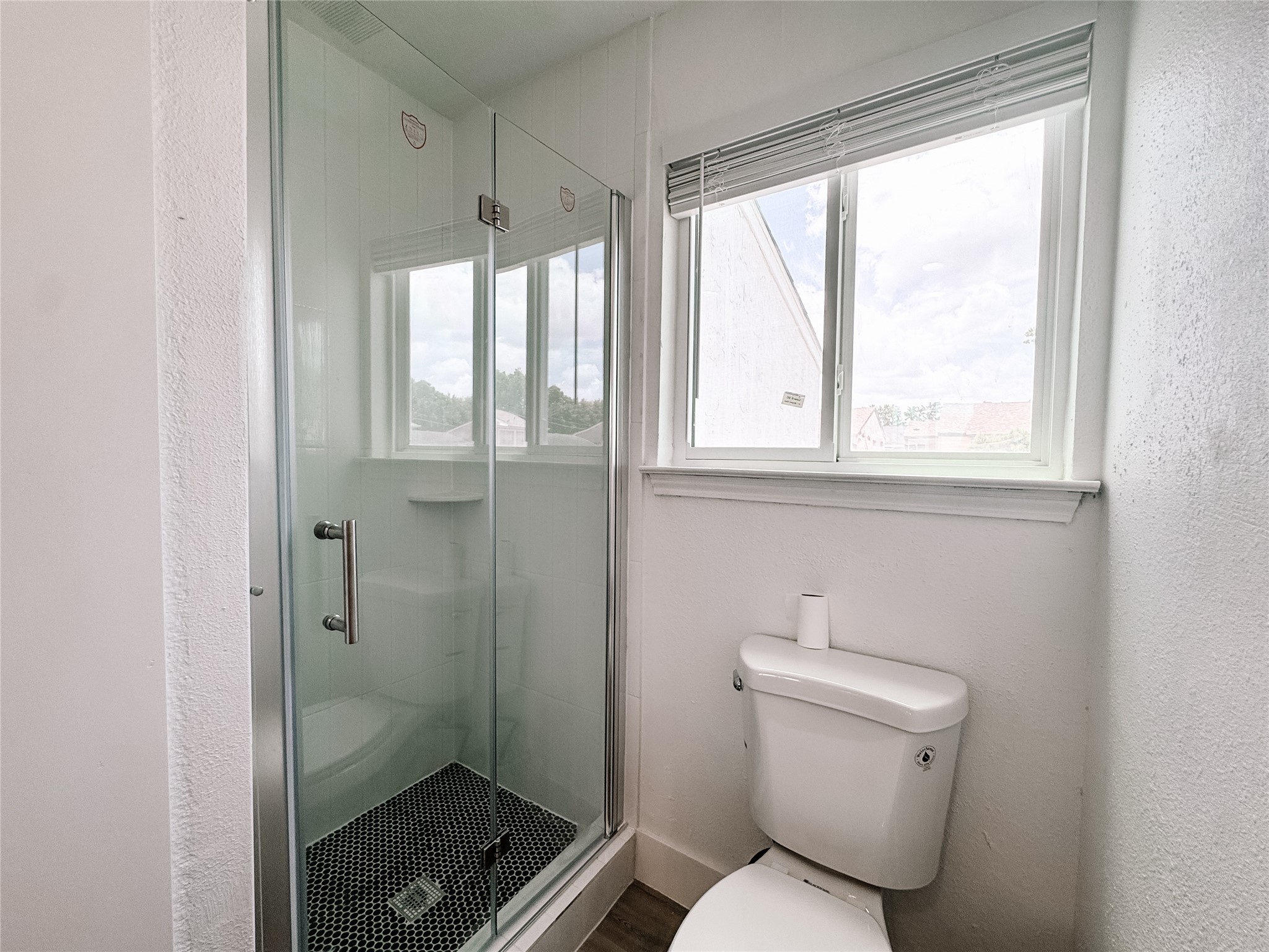 12524 Pebblestone Street Houston, TX 77072 - Photo 11 of 16 a bathroom with a toilet and a shower