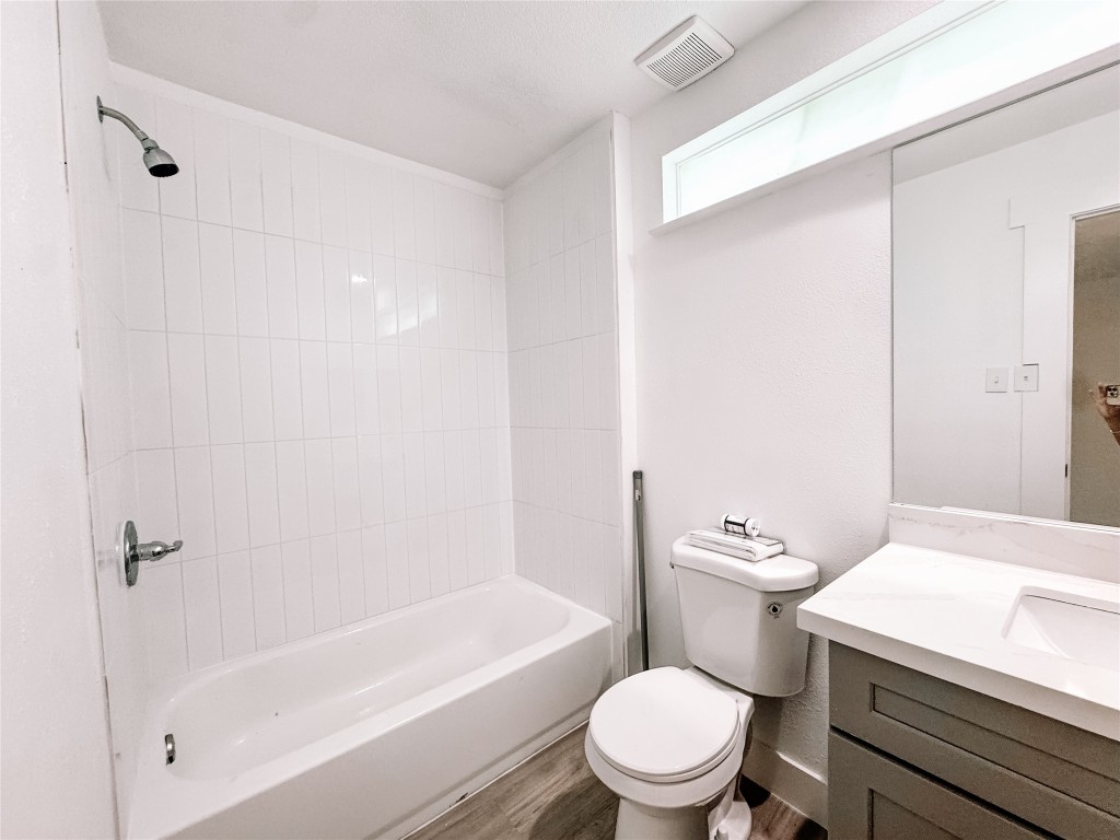 12524 Pebblestone Street Houston, TX 77072 - Photo 15 of 16 a white toilet sitting next to a bath tub