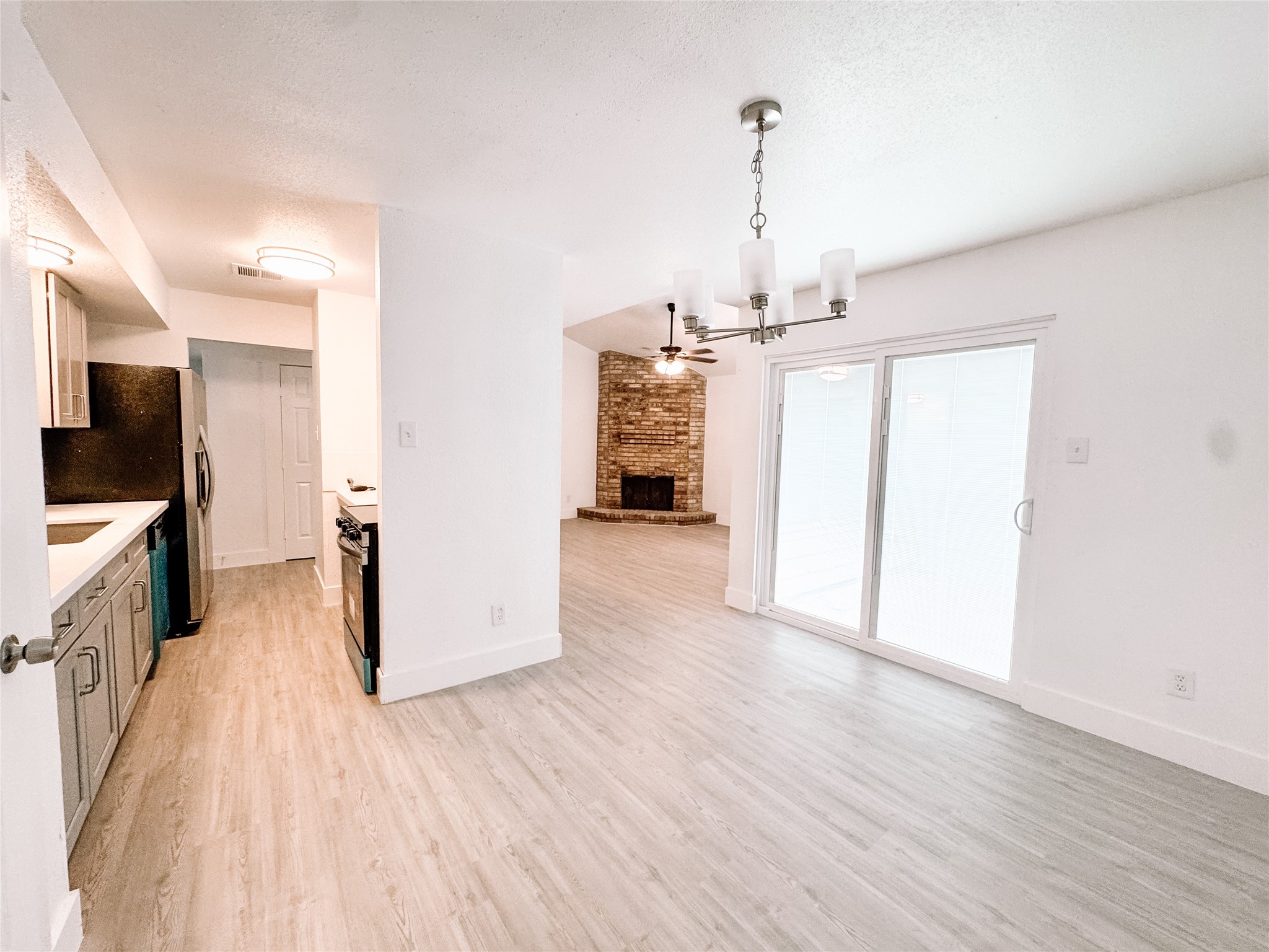 12524 Pebblestone Street Houston, TX 77072 - Photo 2 of 16 a view of a kitchen with a sink and a refrigerator