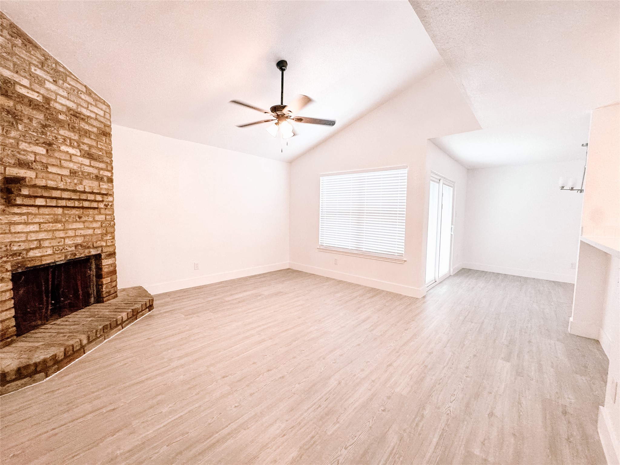 12524 Pebblestone Street Houston, TX 77072 - Photo 3 of 16 an empty room with windows and fireplace