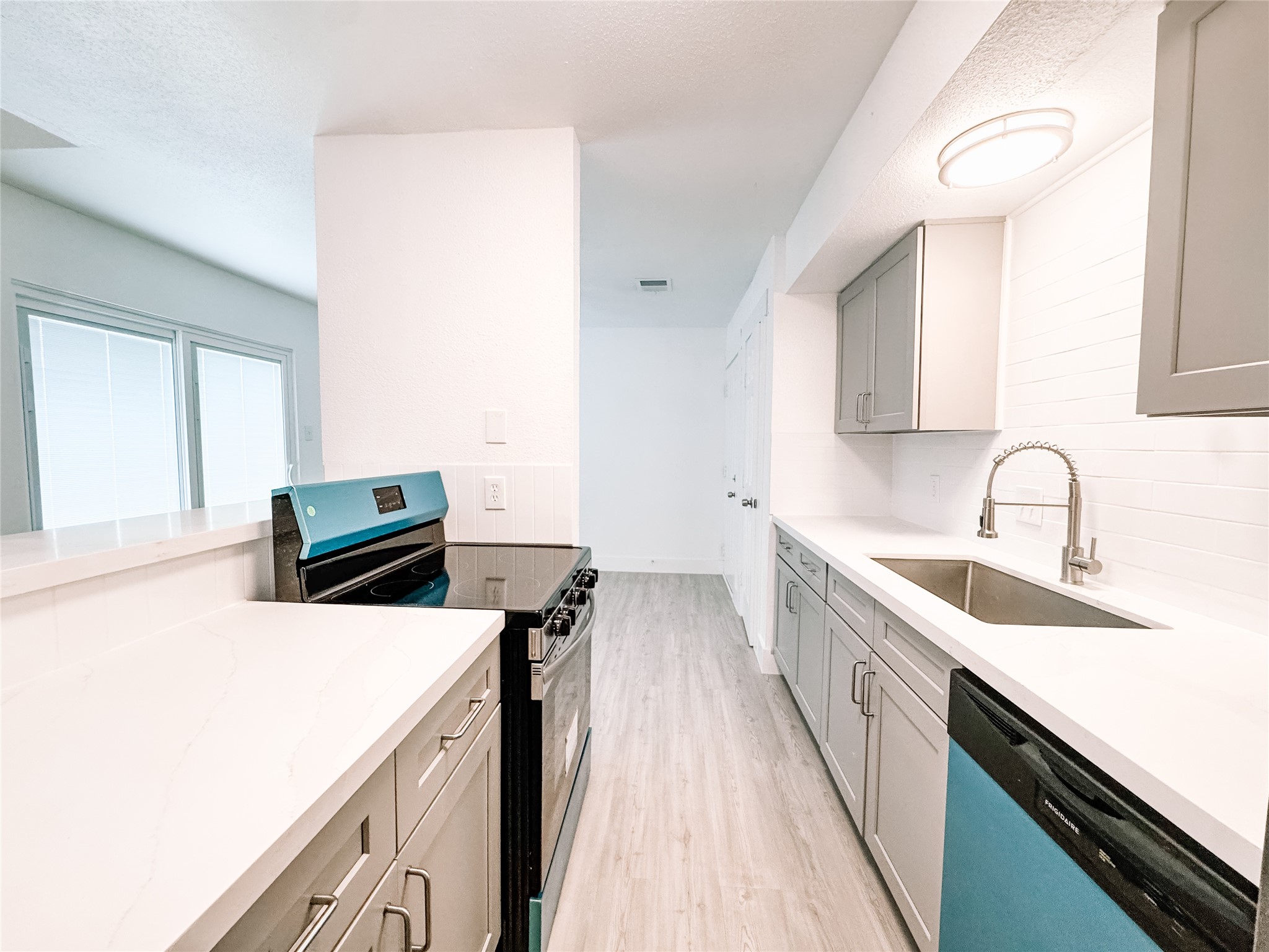 12524 Pebblestone Street Houston, TX 77072 - Photo 6 of 16 a kitchen that has a sink and a stove