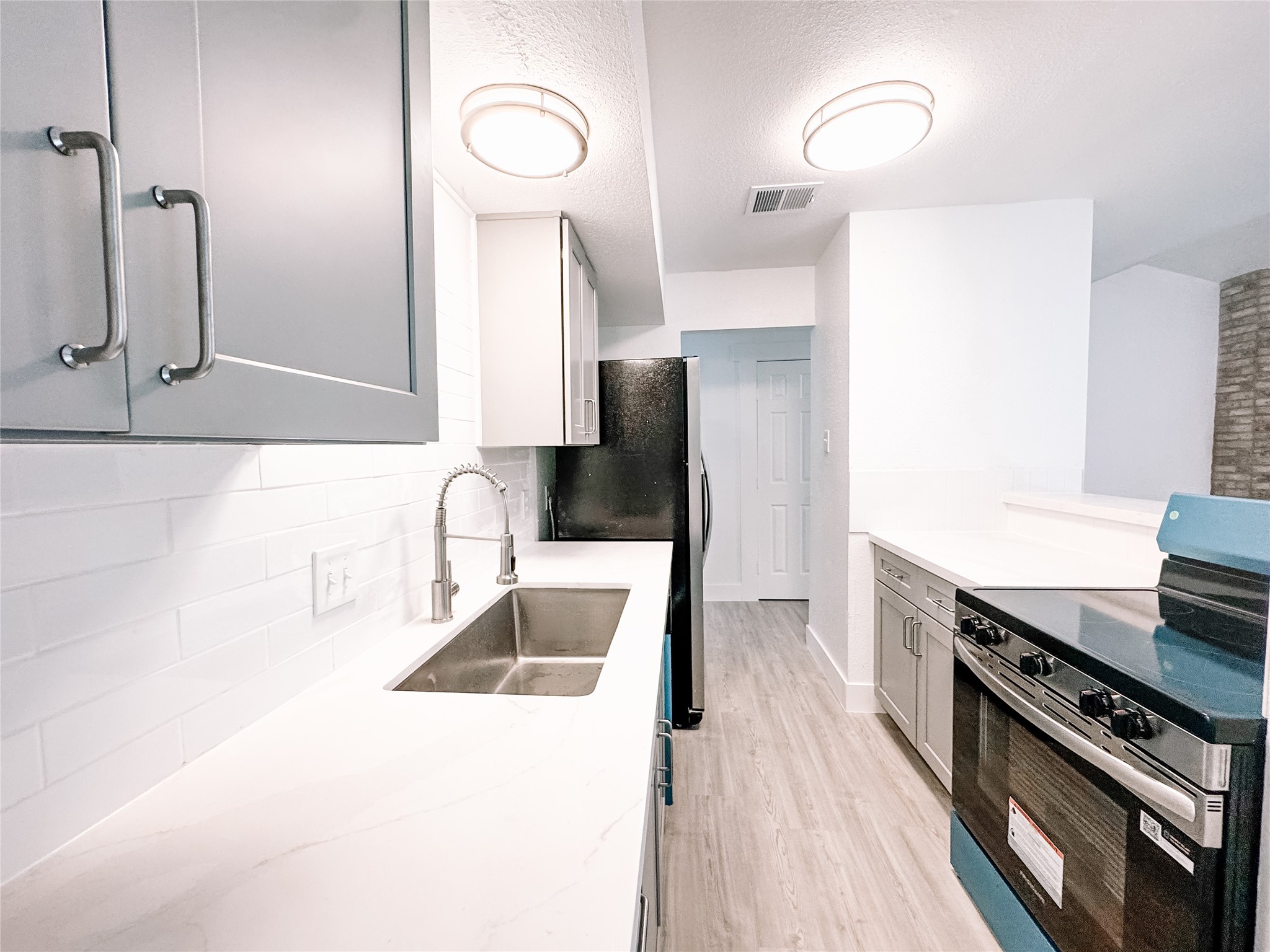 12524 Pebblestone Street Houston, TX 77072 - Photo 7 of 16 a kitchen with stainless steel appliances granite countertop a sink and a stove