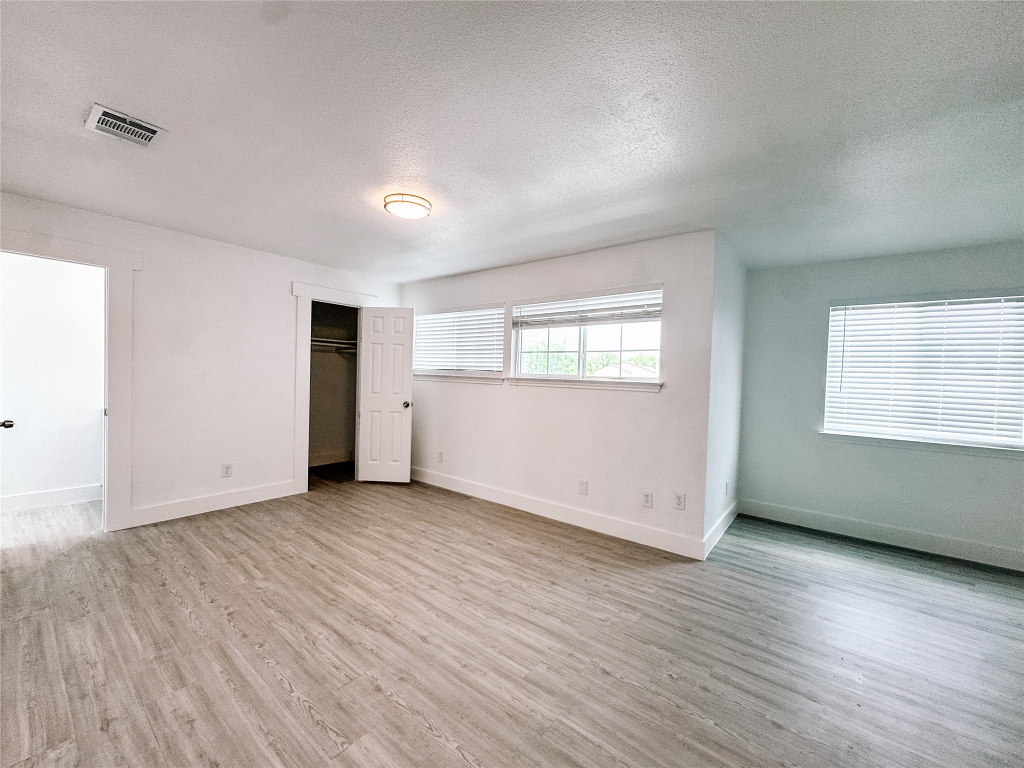 12524 Pebblestone Street Houston, TX 77072 - Photo 10 of 16 an empty room with wooden floor and windows