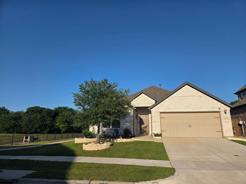 1512 Springtree Drive McKinney, TX 75071 - Photo 1 of 23 a front view of a house with a yard
